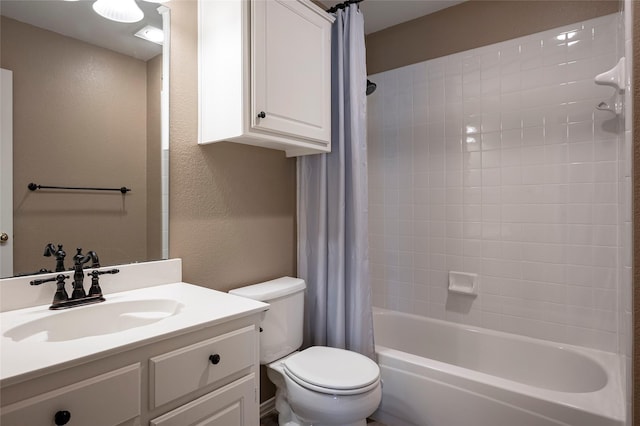 full bathroom with vanity, shower / bath combo, and toilet