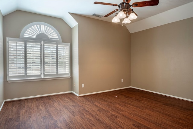 unfurnished room featuring lofted ceiling, ceiling fan, dark wood-type flooring, and a healthy amount of sunlight