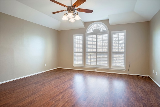 spare room with lofted ceiling, dark wood-type flooring, and ceiling fan