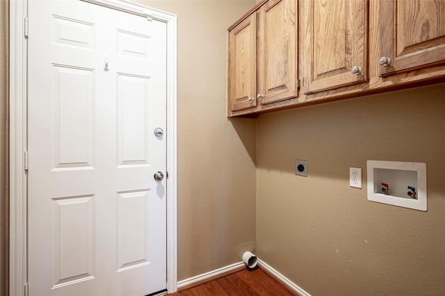 washroom featuring cabinets, dark hardwood / wood-style flooring, hookup for a washing machine, and electric dryer hookup