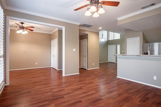 unfurnished living room with ceiling fan, ornamental molding, and dark hardwood / wood-style flooring