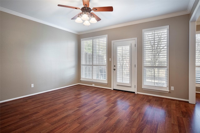 unfurnished room with ornamental molding, a healthy amount of sunlight, and dark hardwood / wood-style floors