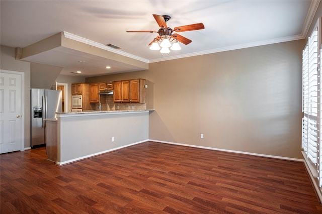 kitchen with dark wood-type flooring, kitchen peninsula, decorative backsplash, and stainless steel fridge with ice dispenser