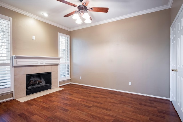 unfurnished living room featuring hardwood / wood-style flooring, a fireplace, ornamental molding, and ceiling fan