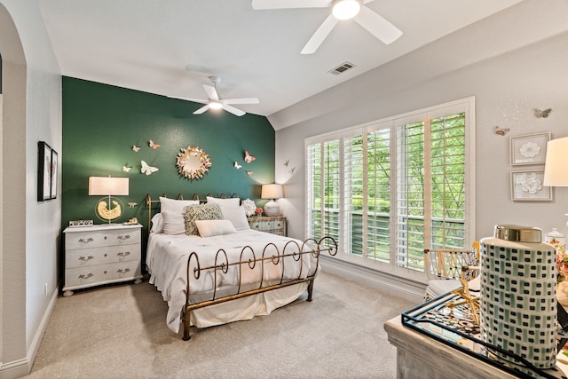 carpeted bedroom featuring arched walkways, a ceiling fan, and baseboards