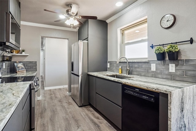 kitchen with a sink, light stone countertops, stainless steel appliances, crown molding, and backsplash