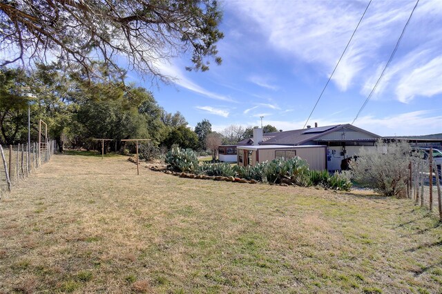 view of yard with a rural view and an outdoor structure