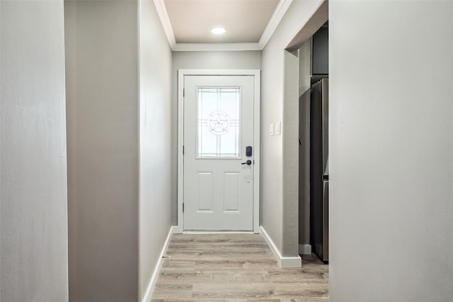 doorway to outside with crown molding and light wood-type flooring