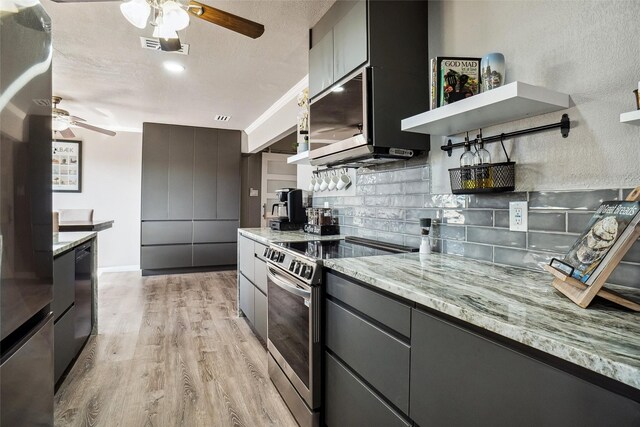 kitchen with tasteful backsplash, light stone counters, stainless steel electric range, light hardwood / wood-style flooring, and ceiling fan