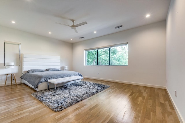 bedroom with light hardwood / wood-style floors and ceiling fan