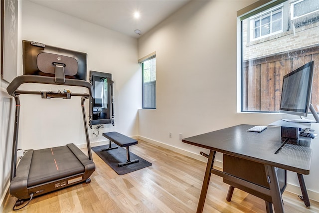 workout area with light hardwood / wood-style floors