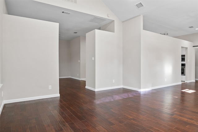 spare room featuring dark wood-type flooring