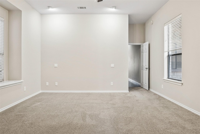 unfurnished room featuring light colored carpet