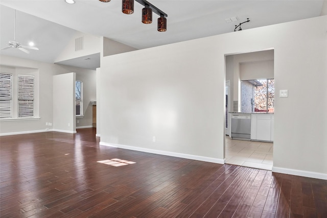 unfurnished living room with lofted ceiling, baseboards, visible vents, ceiling fan, and wood finished floors