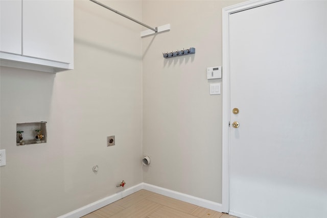 washroom with hookup for a gas dryer, hookup for a washing machine, and cabinets