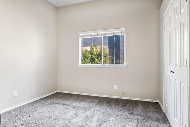 carpeted empty room with baseboards