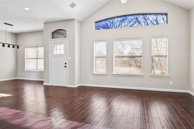foyer featuring lofted ceiling and dark wood-style floors