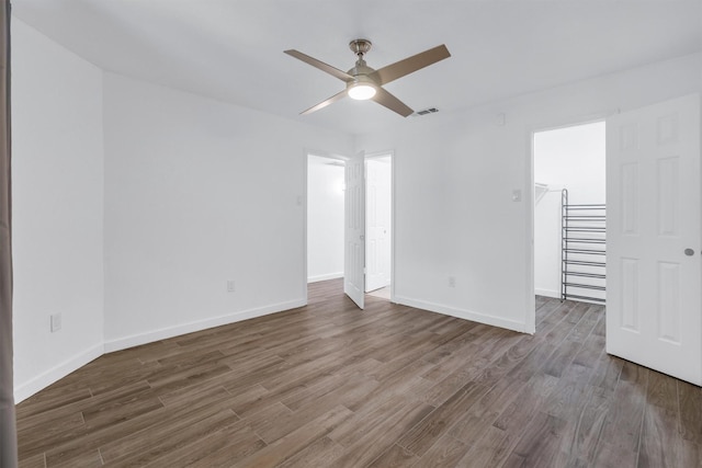 unfurnished room featuring dark wood-type flooring and ceiling fan