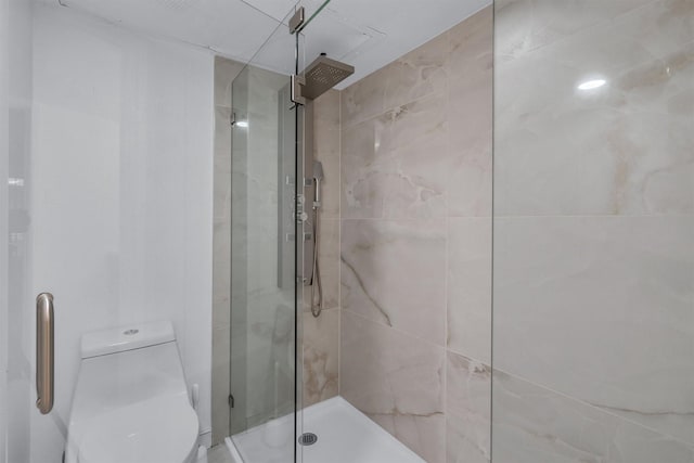 bathroom with an enclosed shower and toilet