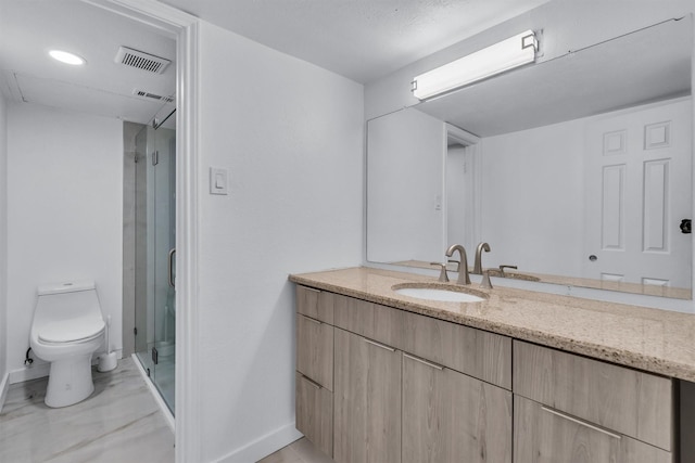 bathroom featuring vanity, toilet, and a shower with door