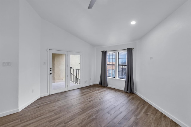 unfurnished room with hardwood / wood-style flooring and lofted ceiling