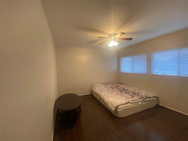 bedroom with dark wood-type flooring and ceiling fan