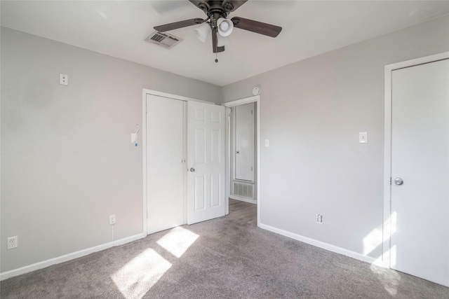 unfurnished bedroom with light colored carpet, ceiling fan, and a closet