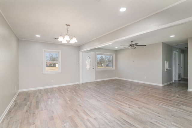 spare room featuring ceiling fan with notable chandelier, ornamental molding, and light hardwood / wood-style floors