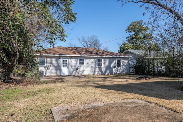 rear view of property featuring a yard