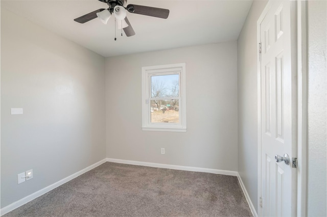 carpeted spare room featuring ceiling fan