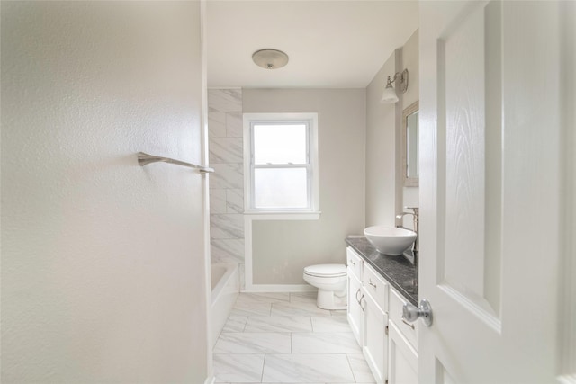 full bathroom featuring vanity, tiled shower / bath, and toilet