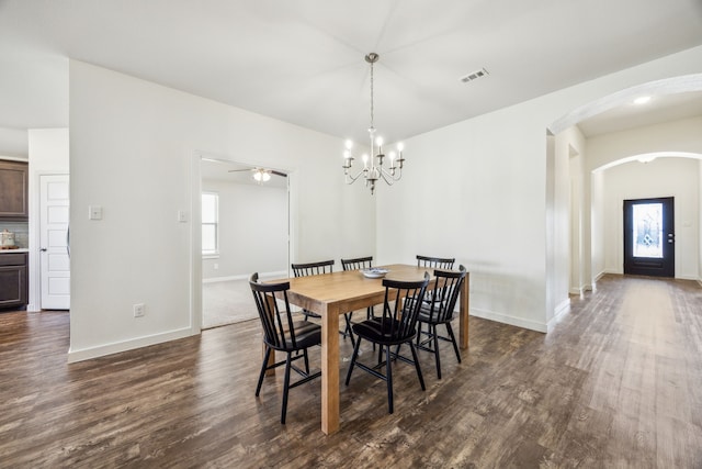 dining area featuring a notable chandelier and dark hardwood / wood-style flooring