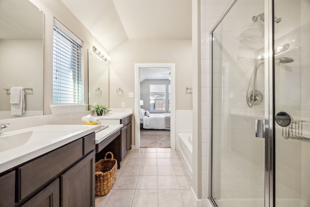 bathroom featuring lofted ceiling, separate shower and tub, tile patterned flooring, and vanity