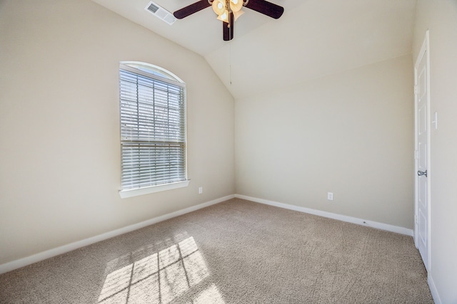 spare room with carpet floors, vaulted ceiling, and ceiling fan