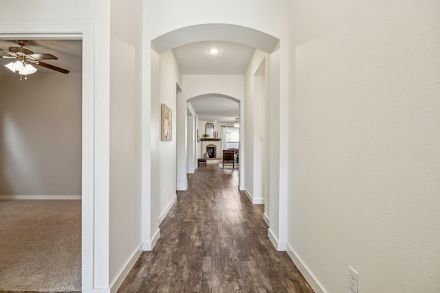 corridor with dark hardwood / wood-style flooring