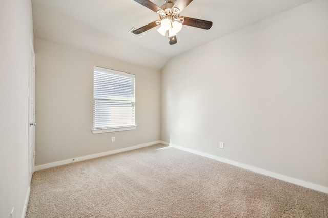 carpeted spare room featuring lofted ceiling and ceiling fan