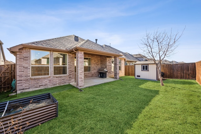 rear view of property featuring a storage shed, a yard, and a patio