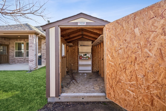 view of exterior entry with a lawn