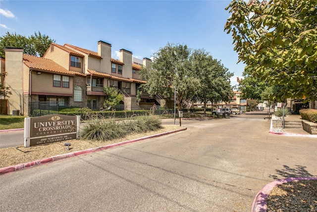 view of road featuring a residential view and curbs