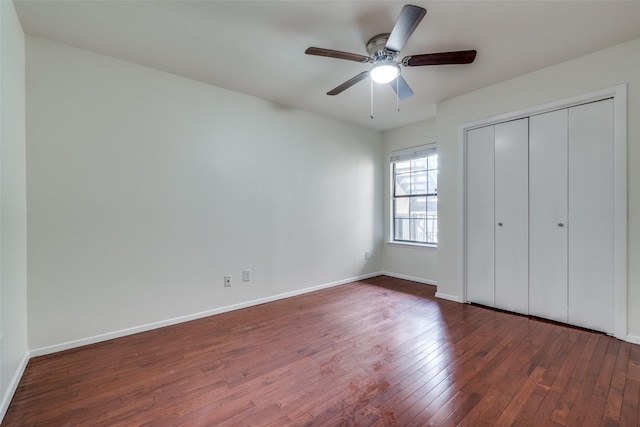 unfurnished bedroom featuring dark wood-type flooring, ceiling fan, and a closet