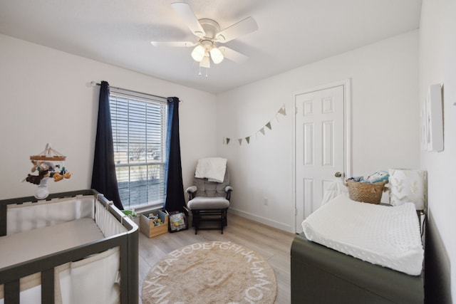 bedroom with light hardwood / wood-style floors and ceiling fan