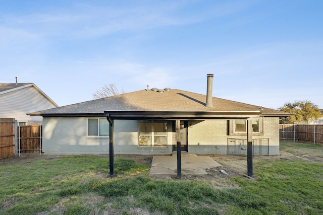 back of property with a patio area and a lawn