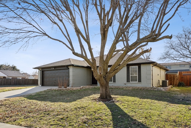 ranch-style home featuring a garage, cooling unit, and a front lawn