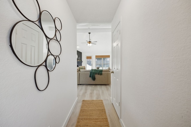 corridor with light hardwood / wood-style floors