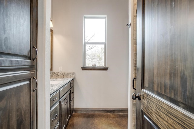 bathroom featuring concrete flooring and vanity