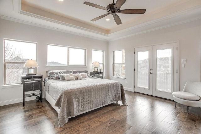 bedroom with a tray ceiling, access to outside, french doors, and dark wood-type flooring