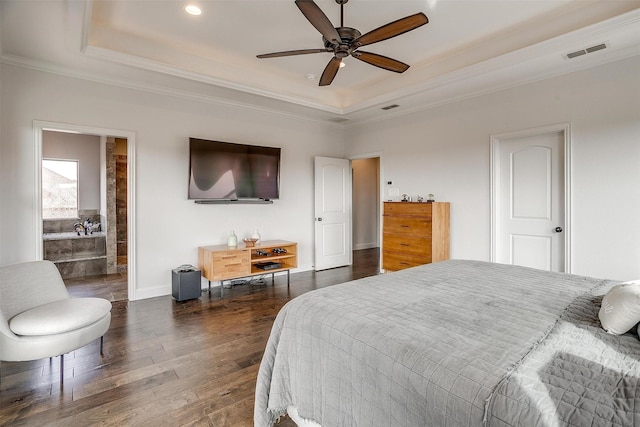 bedroom with a raised ceiling, crown molding, and dark wood-type flooring