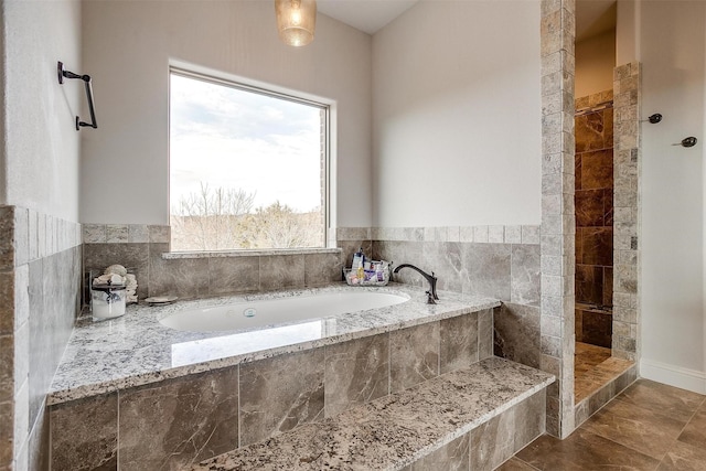 bathroom featuring independent shower and bath and tile patterned flooring