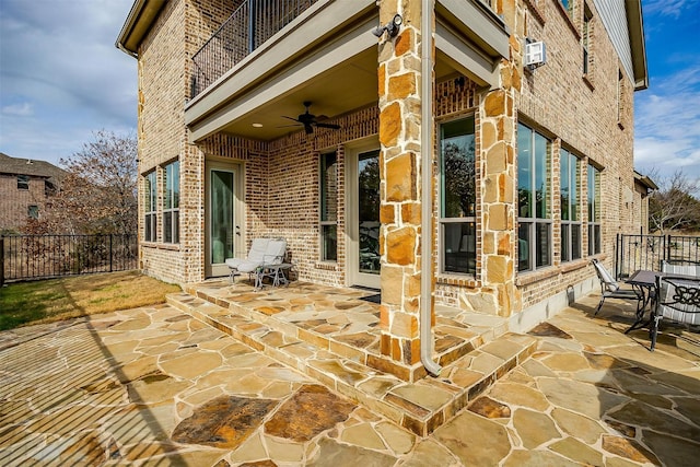 view of patio / terrace with a balcony and ceiling fan