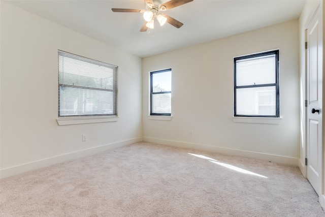 unfurnished room featuring ceiling fan and light carpet